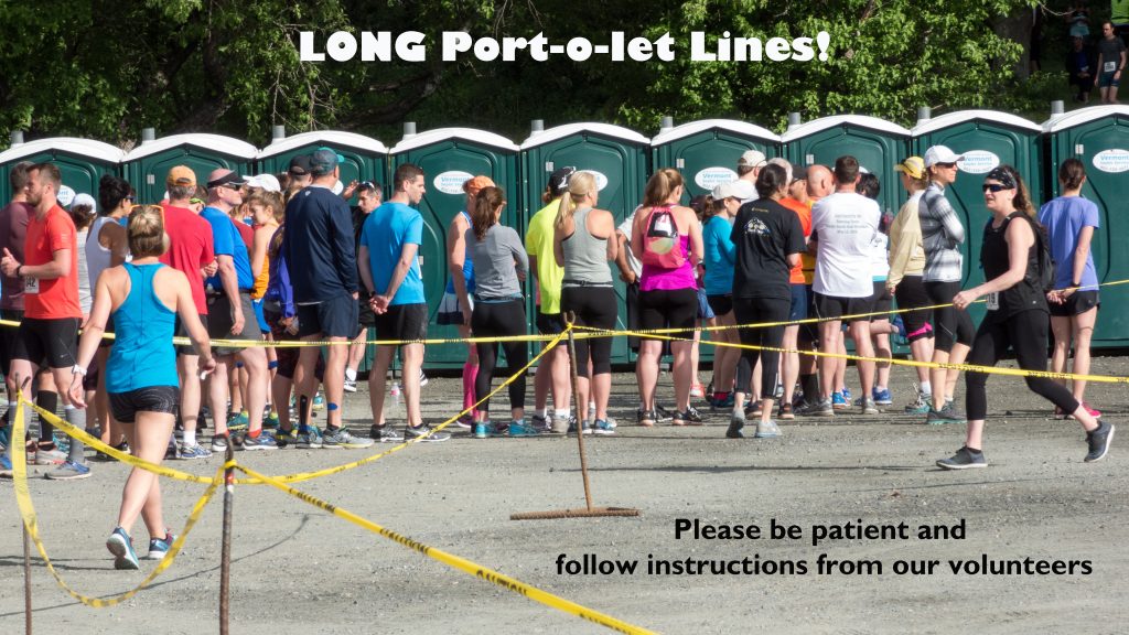 As runners in a marathon go by, volunteers hand them small cone